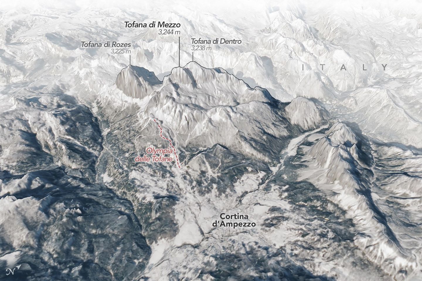 A 3D map shows the town of Cortina d’Ampezzo, Italy, in the foreground with tall peaks in the Dolomites rising behind it. A label indicates the location of the Olympic ski run on a mountain called Tofana di Mezzo. Snow covers the ground in most of the scene.